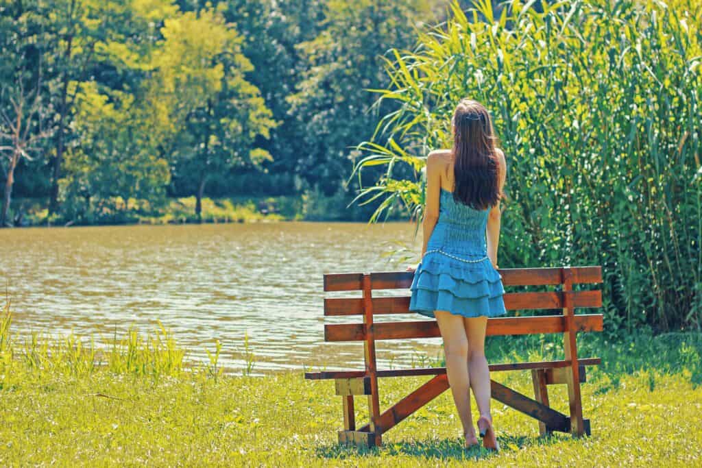 woman looking at lake in the summer
